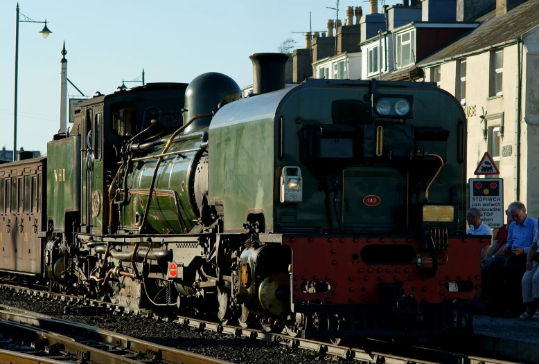 the locomotive car is on a train track