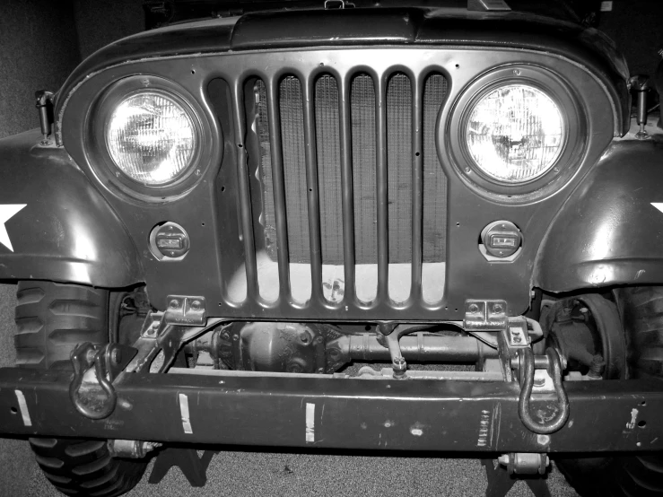 a black and white po of an old jeep front grill