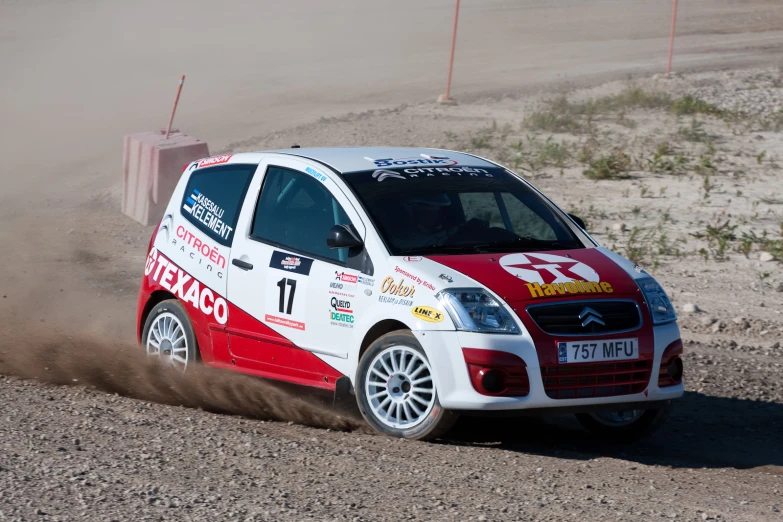 a red and white racing car making a jump