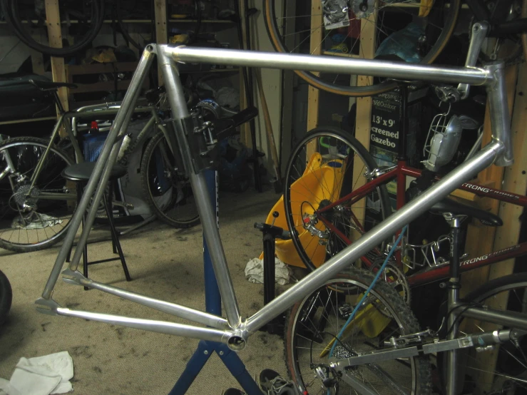 a bike sits near many bikes that are parked in a shop