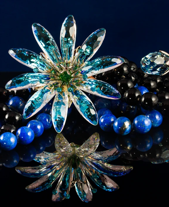 some beads and beads are sitting next to a snowflake