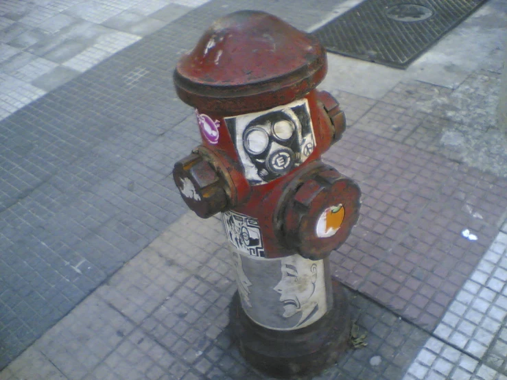 a red fire hydrant with faces drawn on it