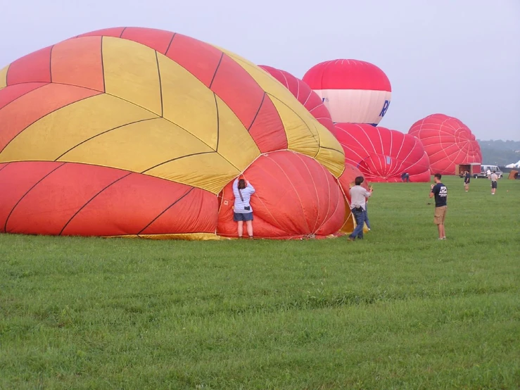 group of people getting ready to fly kites