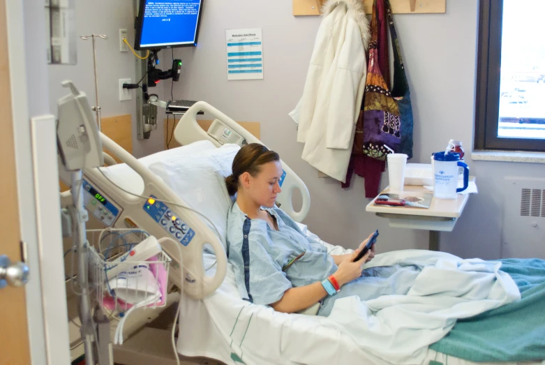 a female doctor using her cell phone in the hospital