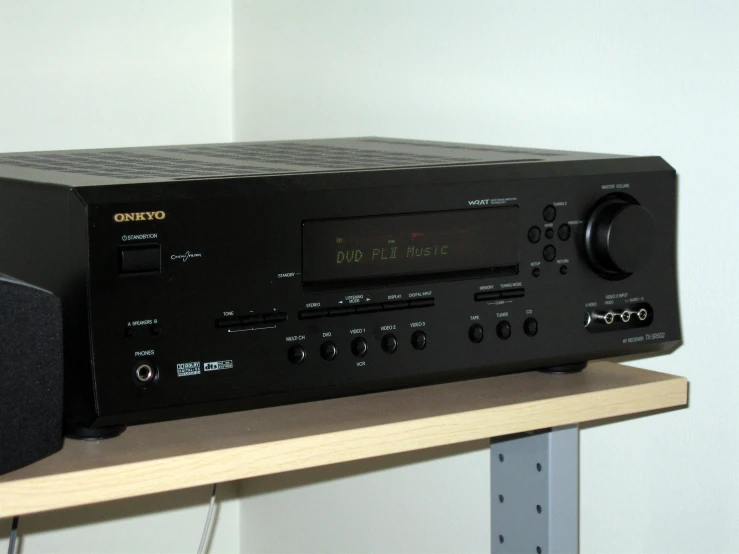 a stereo on top of a shelf with speakers