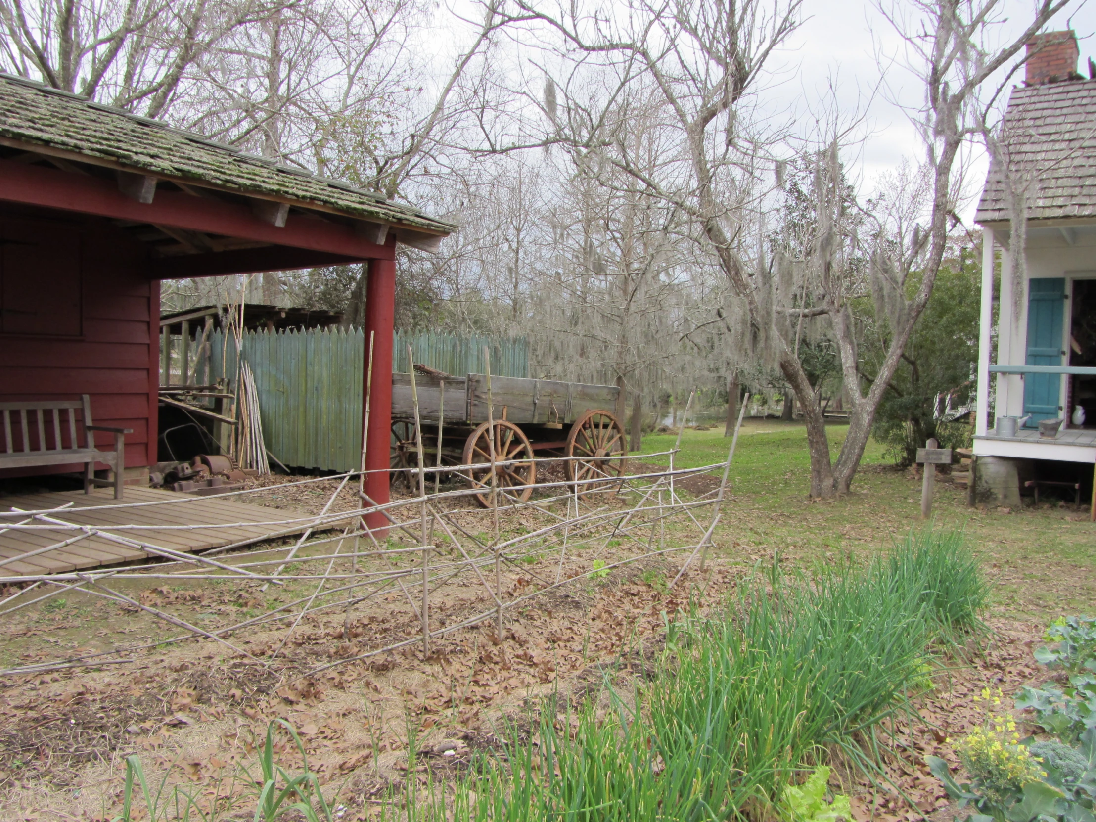 an old farm with a barn and red building