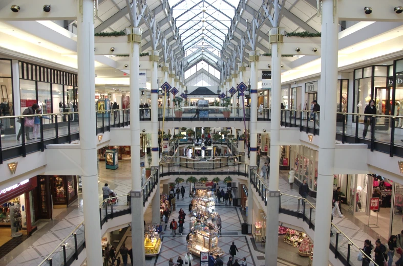 a mall filled with people walking through multiple levels