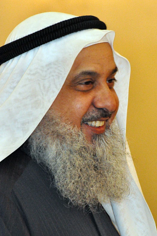 a bearded man in traditional clothing smiling for the camera