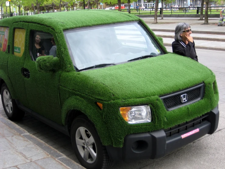 the green van is sitting in the street