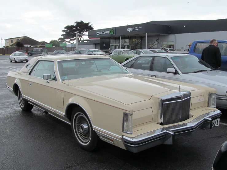 a beige car parked in the parking lot