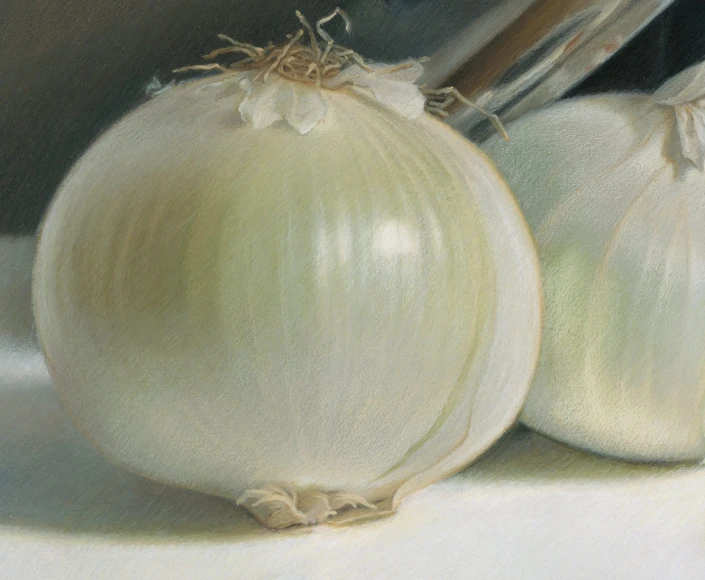 two onions and a knife are on a white surface