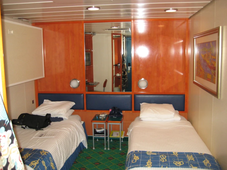 twin beds in a el room with orange cabinets