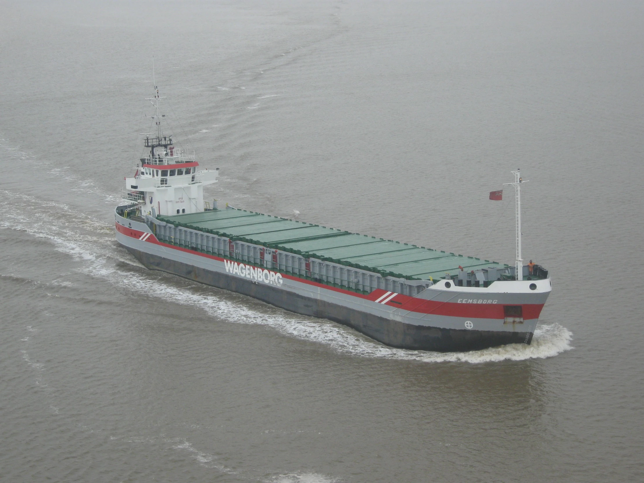 the large cargo ship is on the river water