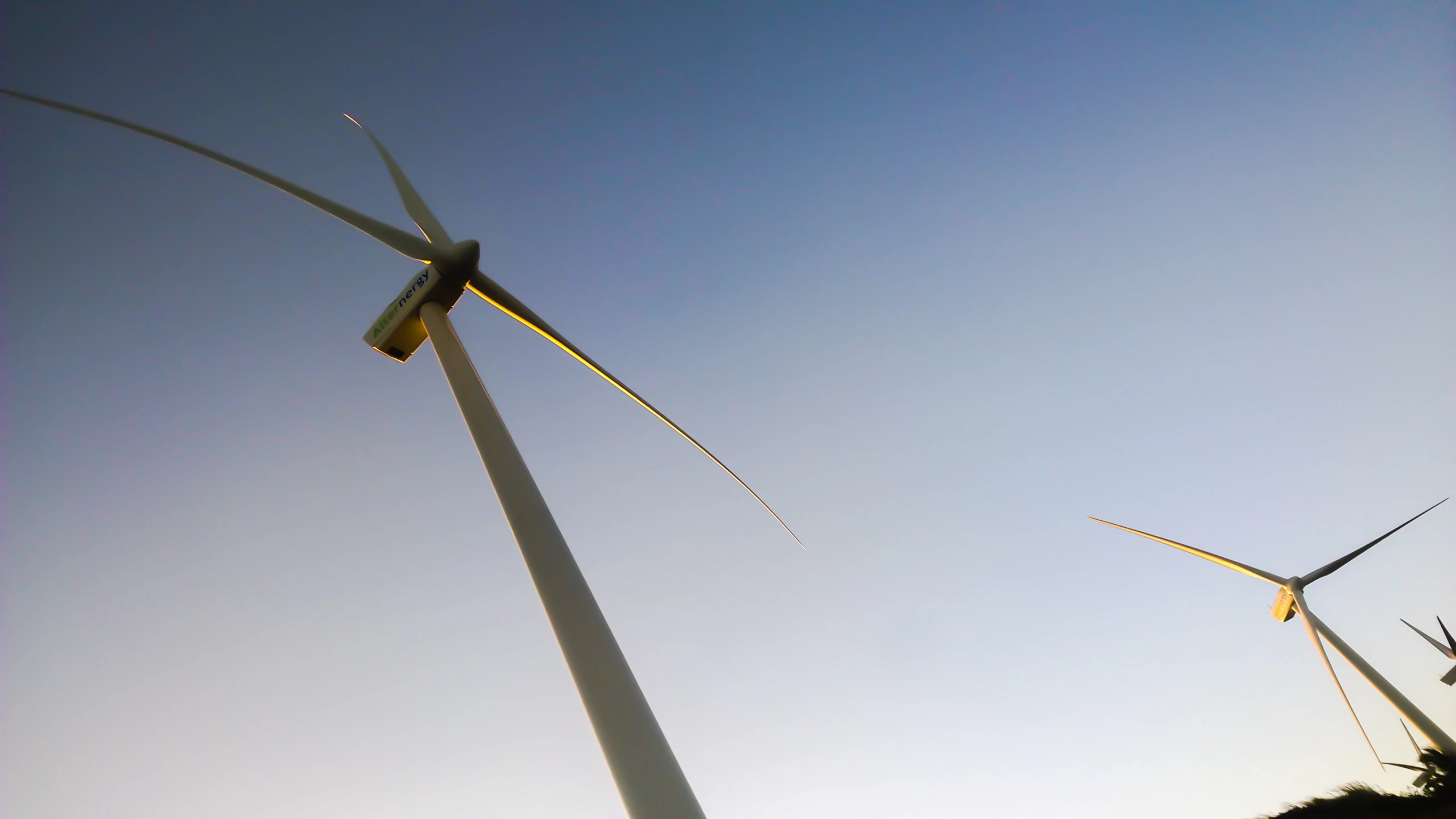 the three large wind generators are all spinning in the same direction