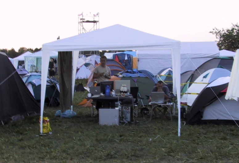 two women standing under a tent at an event