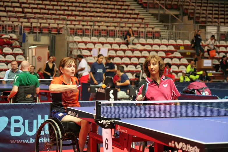 two people playing tennis in front of a crowd