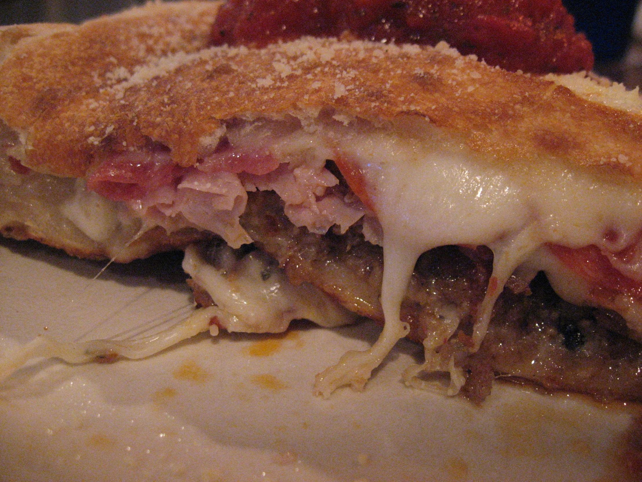 meatball sub sandwich with sauce and cheese on a plate