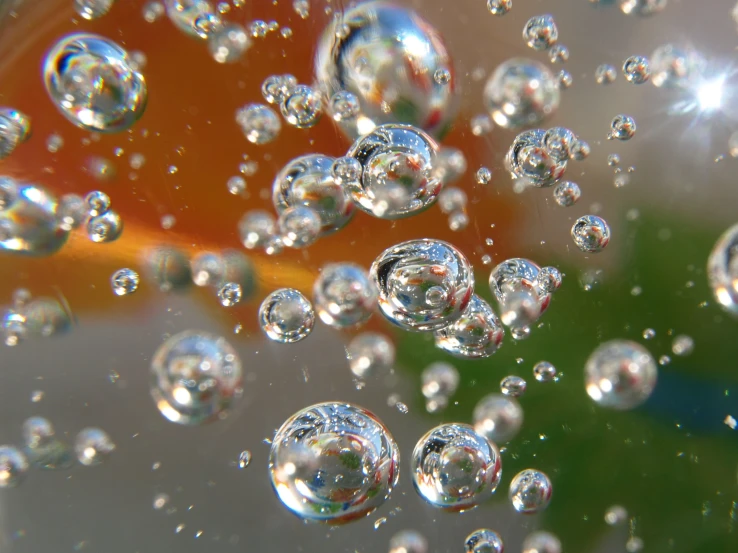 a cluster of bubbles of water are flying