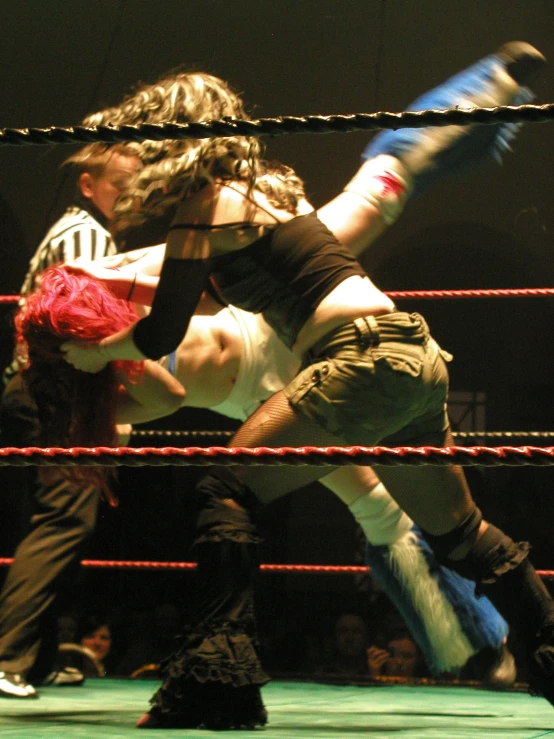 a wrestling match with a wrestler striking the opponent