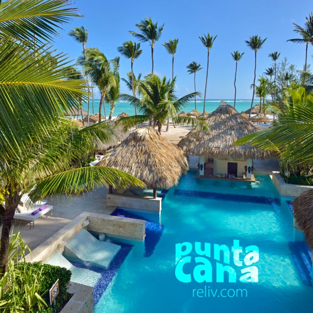 a resort pool with a resort in the background