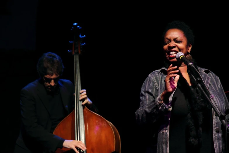 two people are holding onto their instruments together