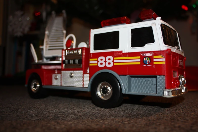 a toy fire truck sitting on top of a floor