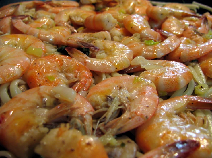 some shrimp and onions are cooking on the stove