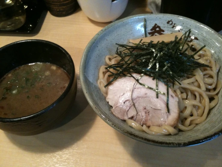 a bowl with some noodles and chicken in it