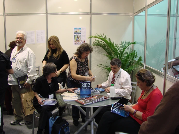 a group of people around a table talking