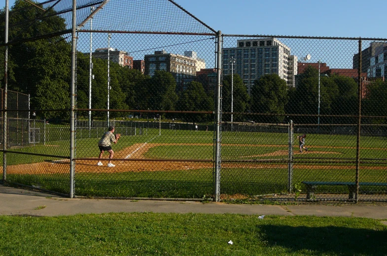 a group of people in baseball uniforms standing on the baseball field