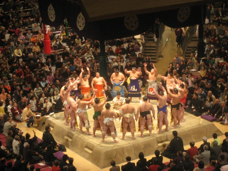 an aerial view of a group of  men on stage