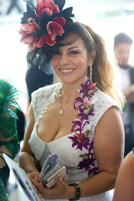 a woman in a white dress with a flower on her head