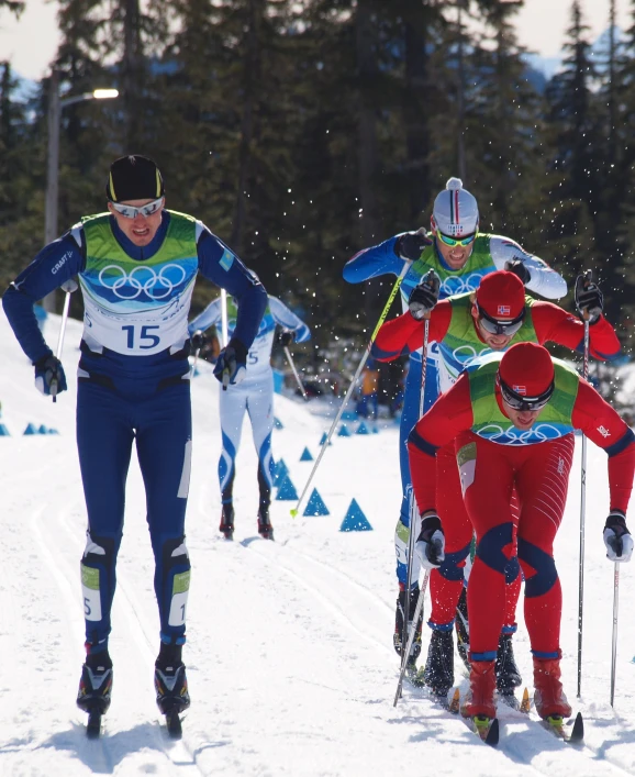 a group of people racing across snow covered ground