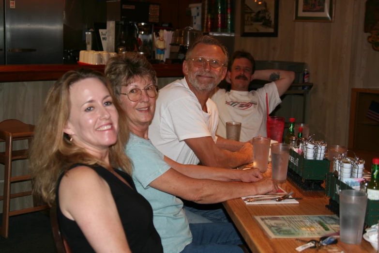 a group of people sitting at a table with glasses