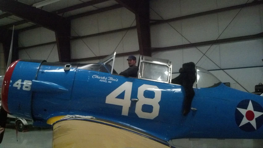 man standing inside the cockpit of an airplane with wings