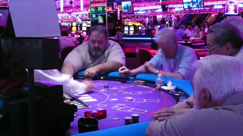 men play cards on a blackjack crap machine