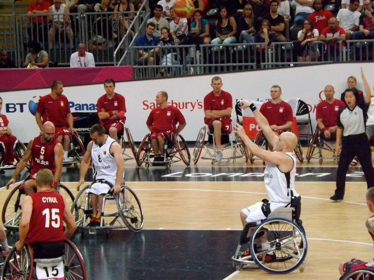 men are playing basketball on a basketball court