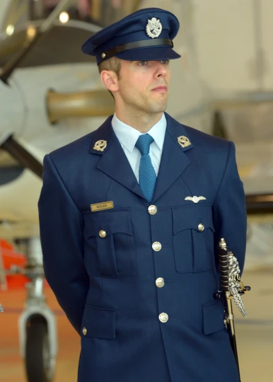 there is an uniformed man wearing a blue uniform