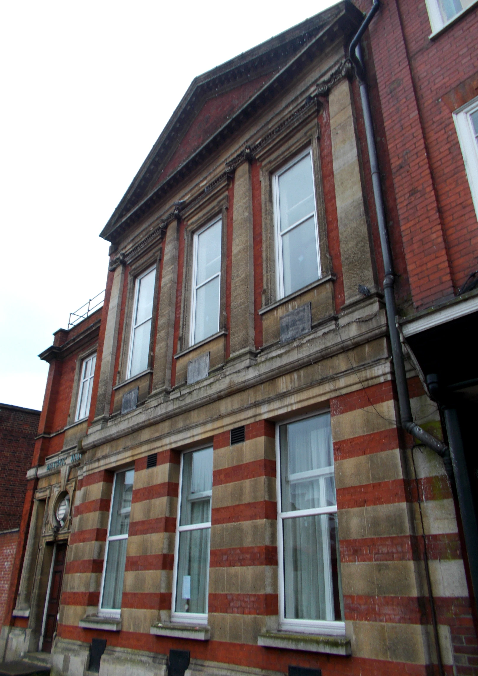 old building on a street corner with lots of windows