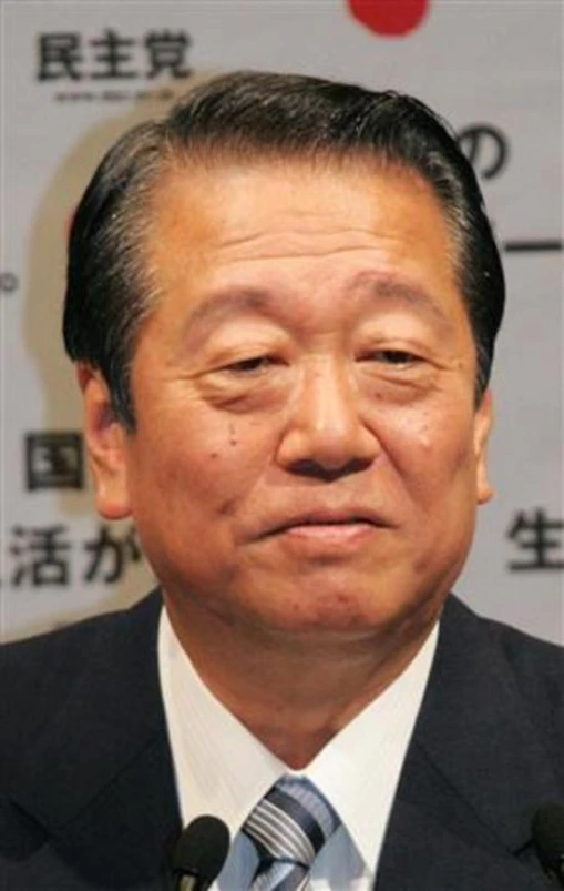 an asian man speaking into microphone at a press conference