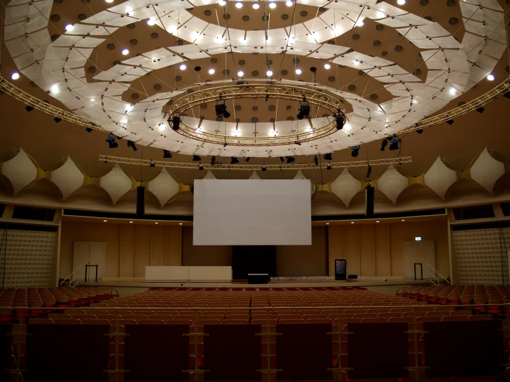 auditorium auditorium stage with overhead speakers and seats