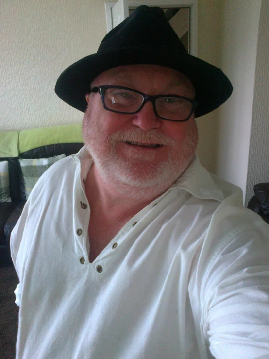 a man wearing a black hat and a white shirt