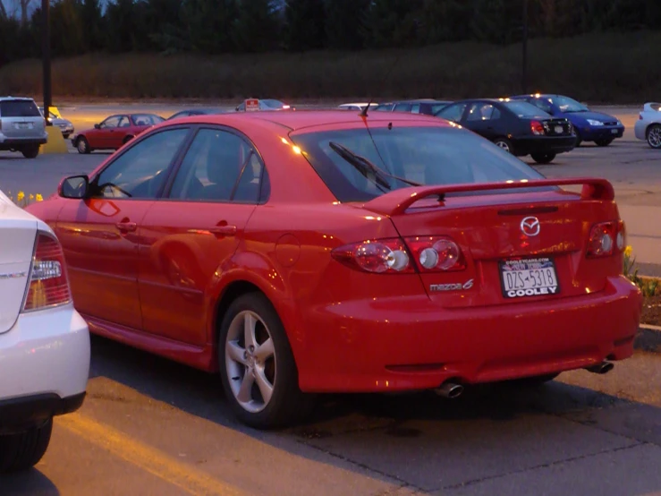 two red cars parked in parking space next to each other