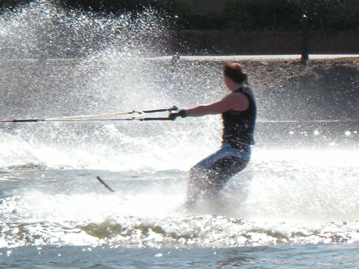 a man who is holding onto his ropes in the water