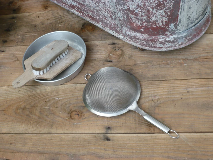 a small round grater next to a metal basket