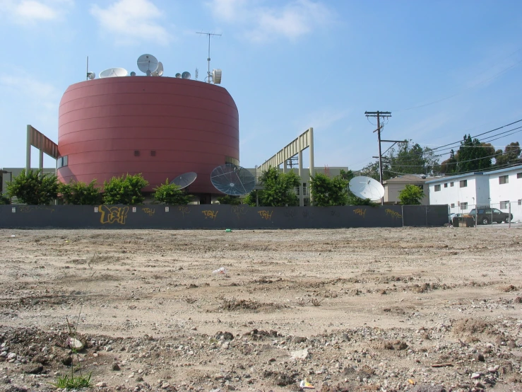 a large pink dome sitting in the middle of a field