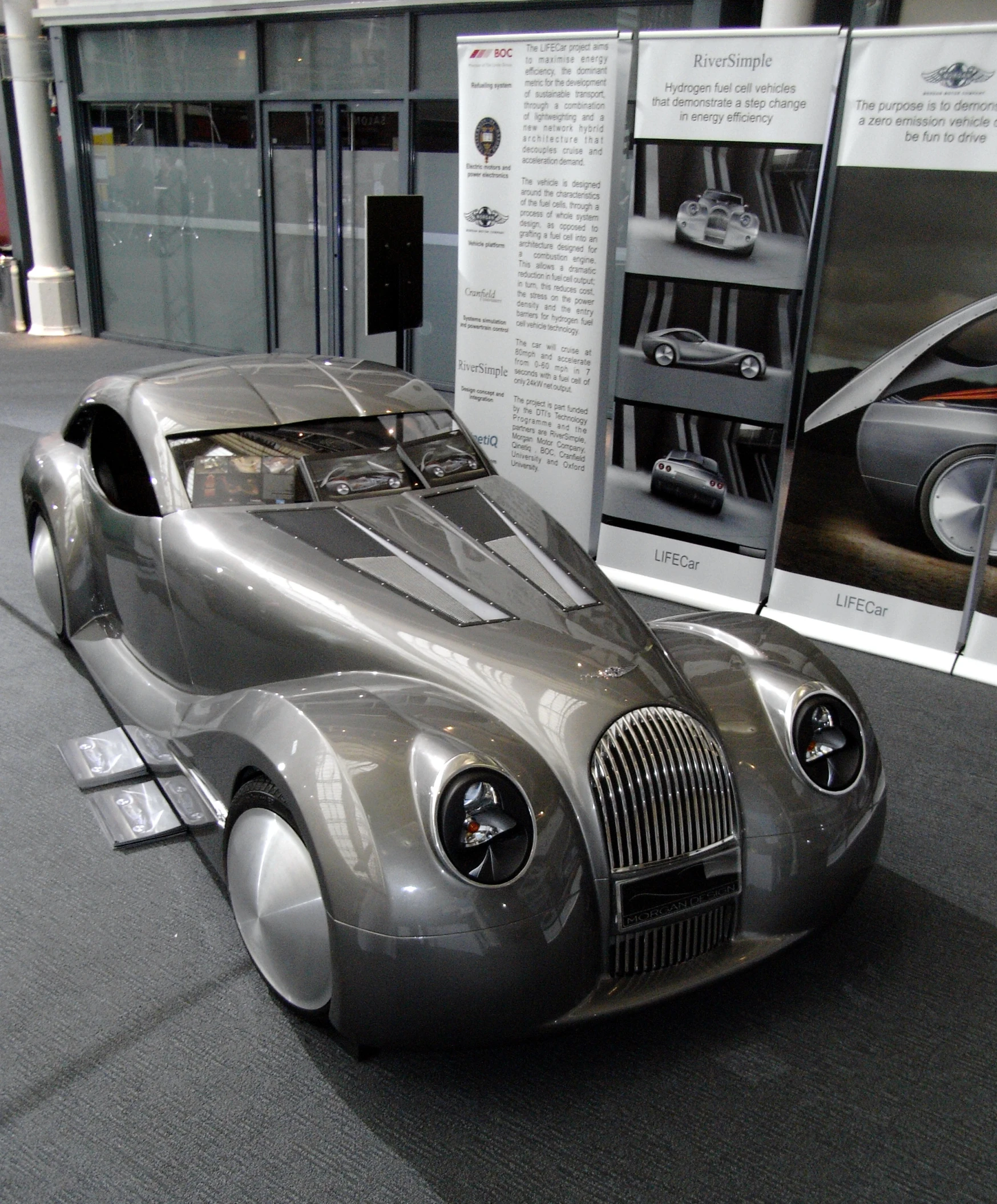 an old fashioned car displayed in front of a museum exhibit