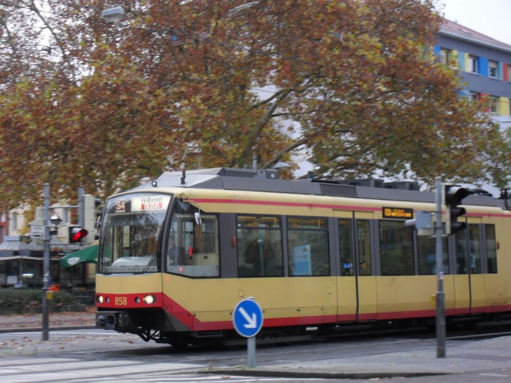 the tram is approaching the train stop on the street