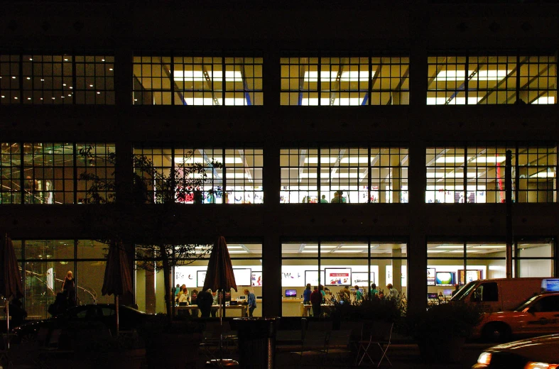 a car is parked outside a lit up building at night