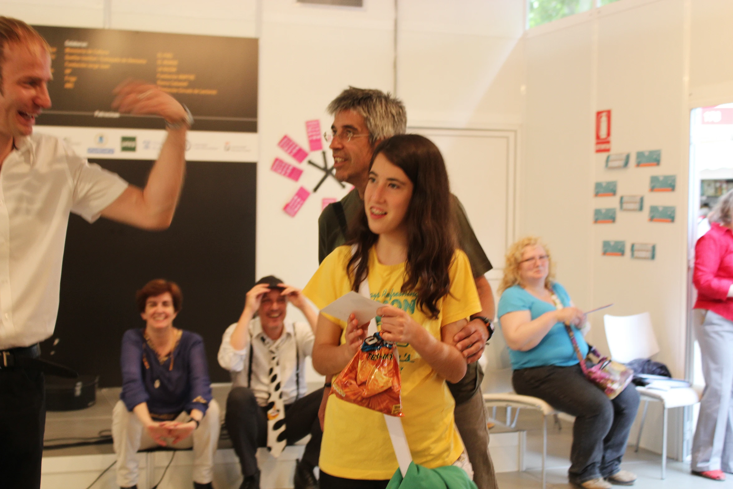 a man and woman playing wii while others watch